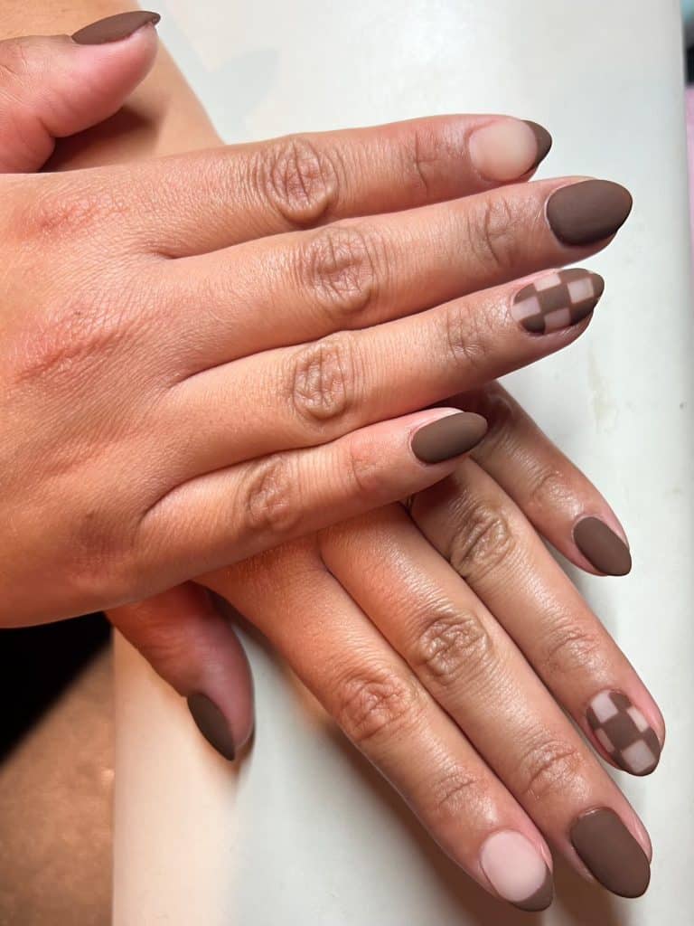 Detailed nail service showcasing precise application and professional results at Inked Beauty Bar.